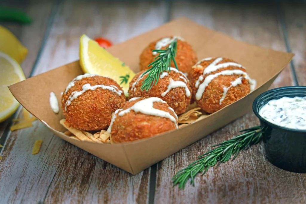 Golden and crispy homemade crab cakes served with lemon wedges and tartar sauce