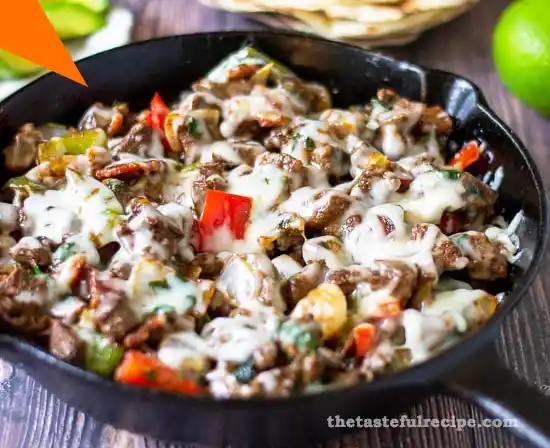 Authentic Mexican Alambre with beef, bell peppers, onions, and melted cheese served with warm tortillas