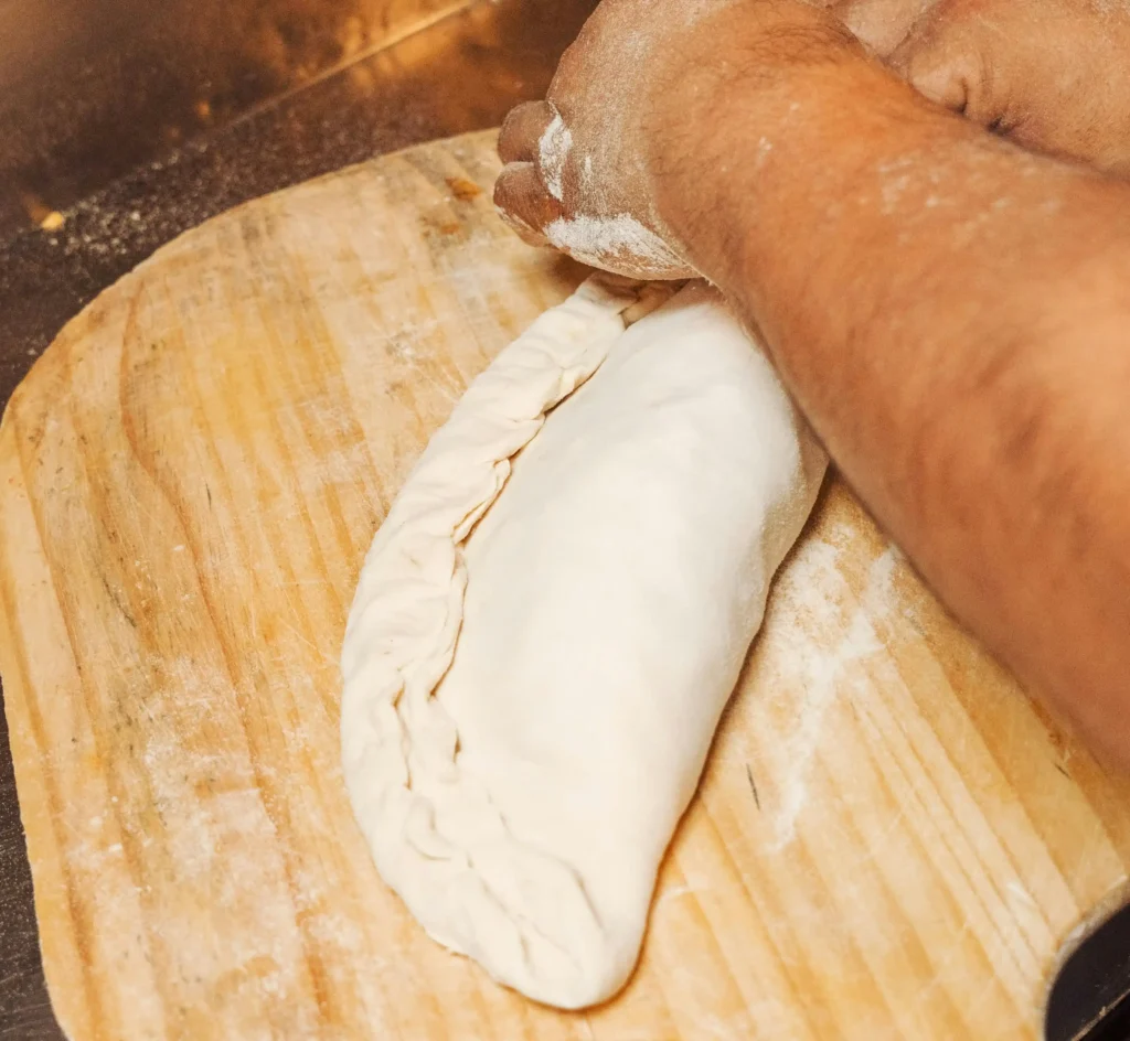 Woman Making Calzone Recipe on a Tray