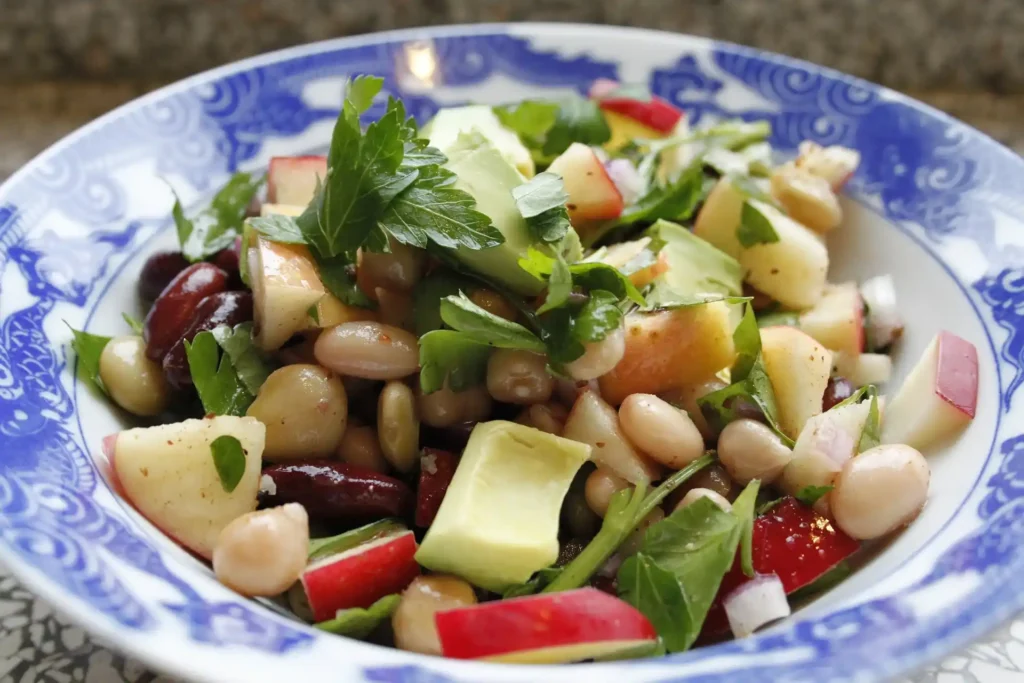 Freshly made Bean Salad served in a white bowl with a tangy vinaigrette dressing