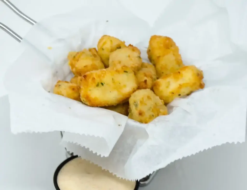 Golden fried Wisconsin cheese curds served hot with dipping sauce