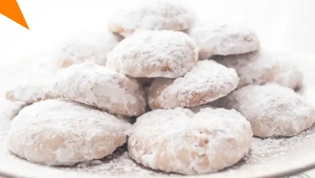 Traditional Mexican Wedding Cookies with a bite showing a nutty inside